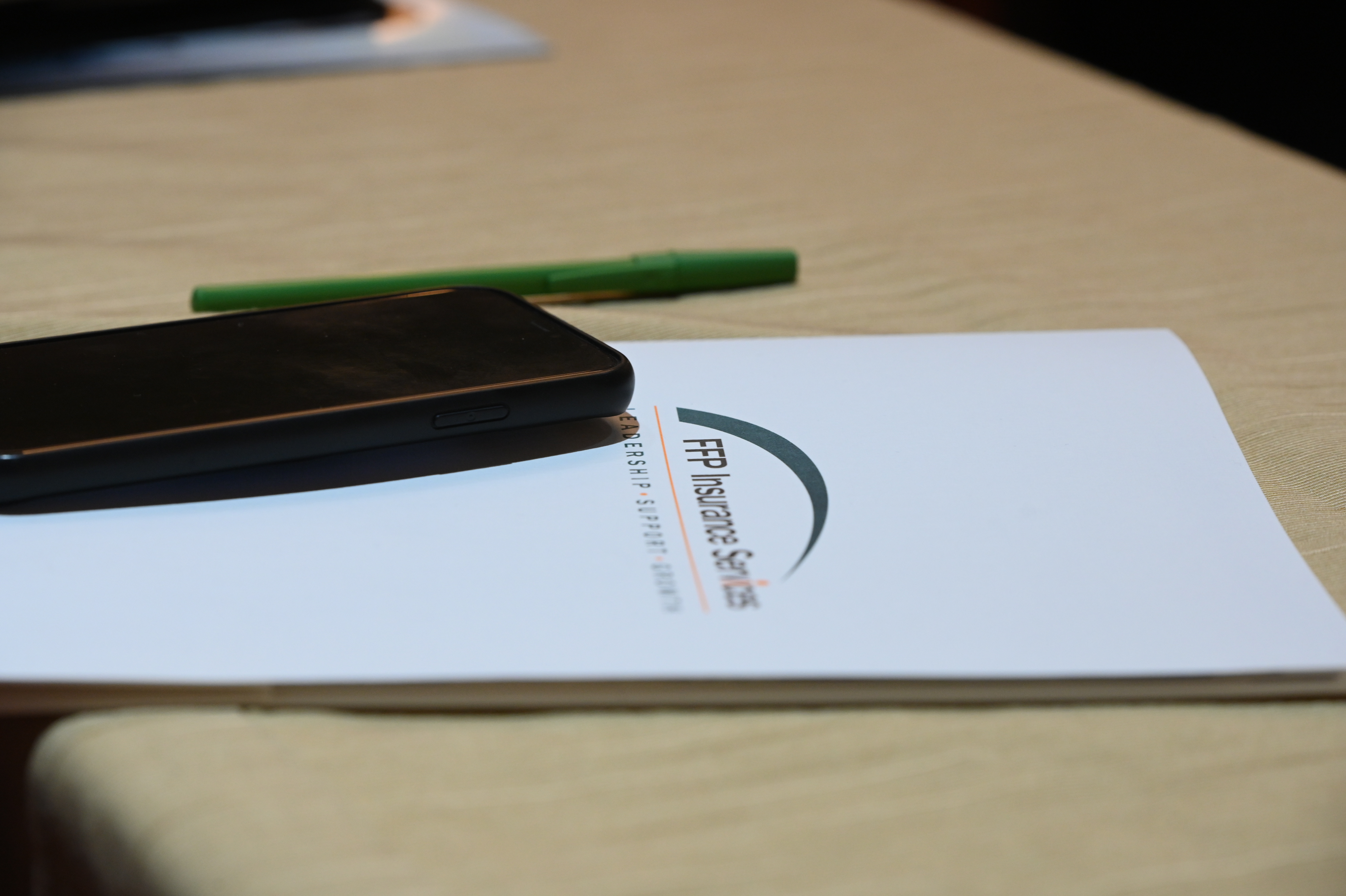 A photo of a folder with FFP's logo on a table.