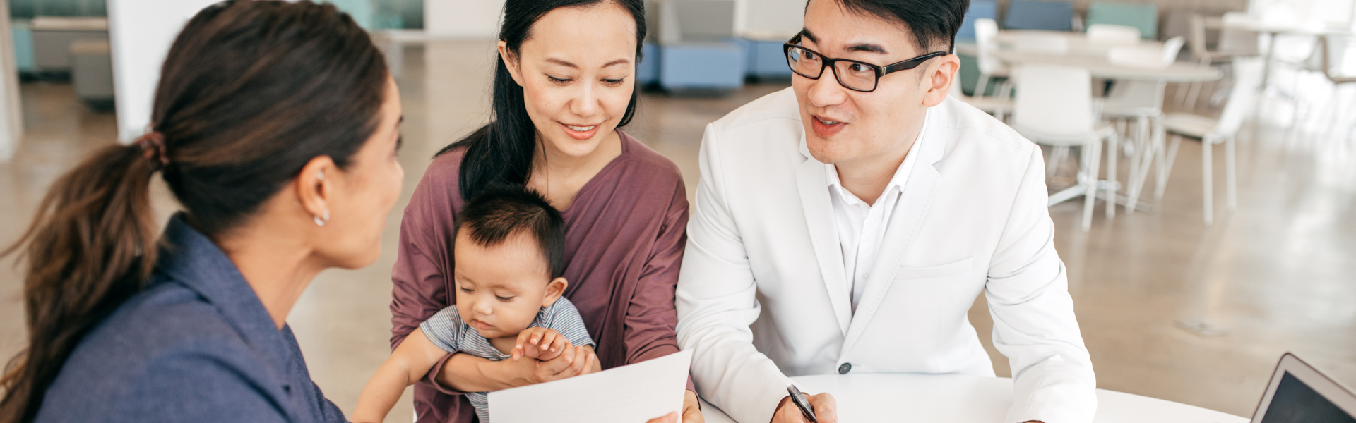 mother and father with baby meeting with agent