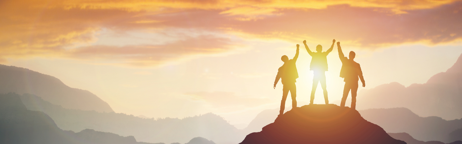 three people on top of mountain