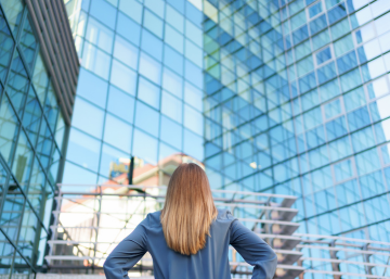 Woman with back towards us facing skyscrapers