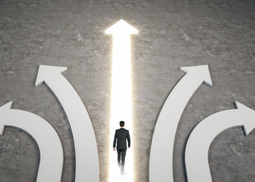 man walking on lit arrow pointing up